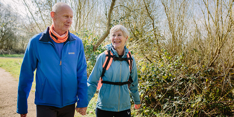 two elderly walkers smiling and talking