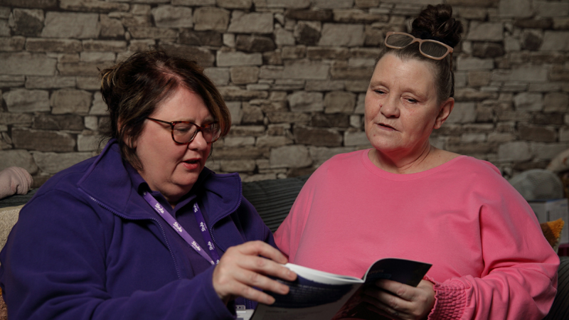 Stroke Association Support Coordinator, Jo, reads through a stroke information booklet with stroke survivor, Julie.